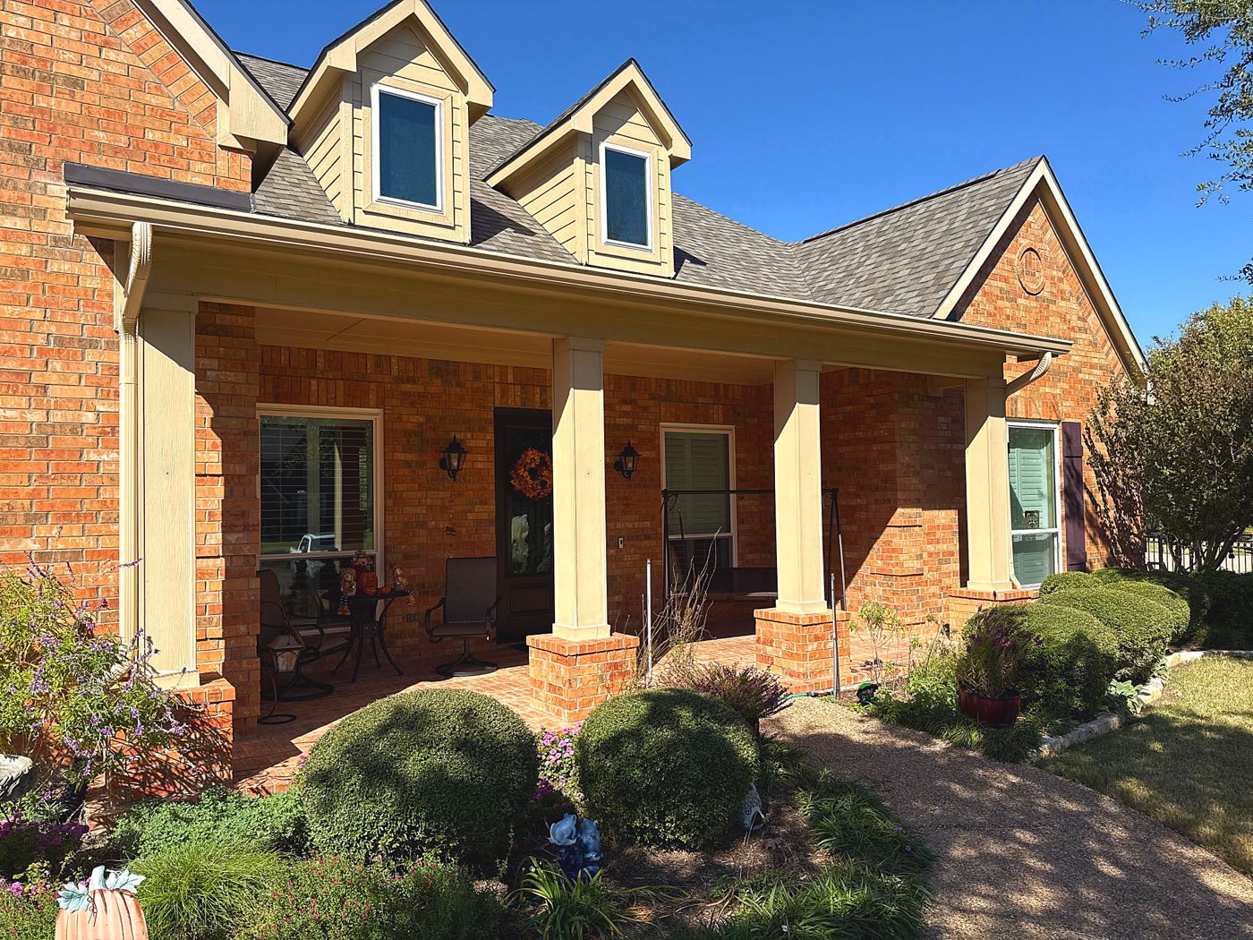 New shingle roof replacement on a two-story brick home by Benchmark Roofing and Construction