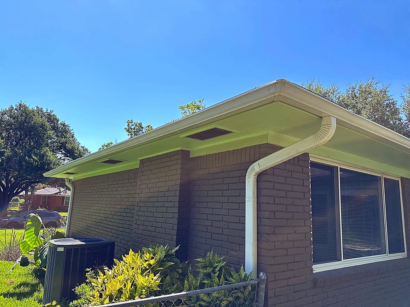 Soffit, fascia, and gutter trim repaired on a Garland-area home, a common spot where wind-driven rain finds its way into the roof deck