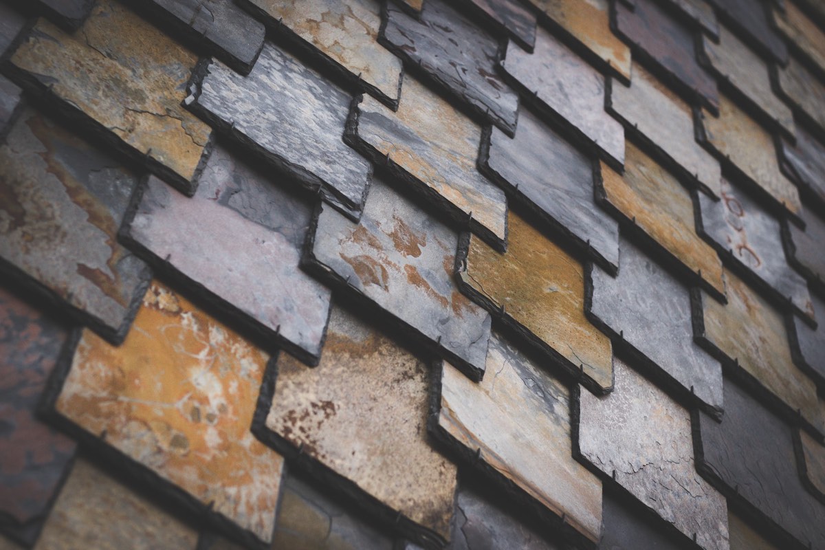 Natural slate roof tiles on a lakeside Rowlett, TX home by Benchmark Roofing and Construction