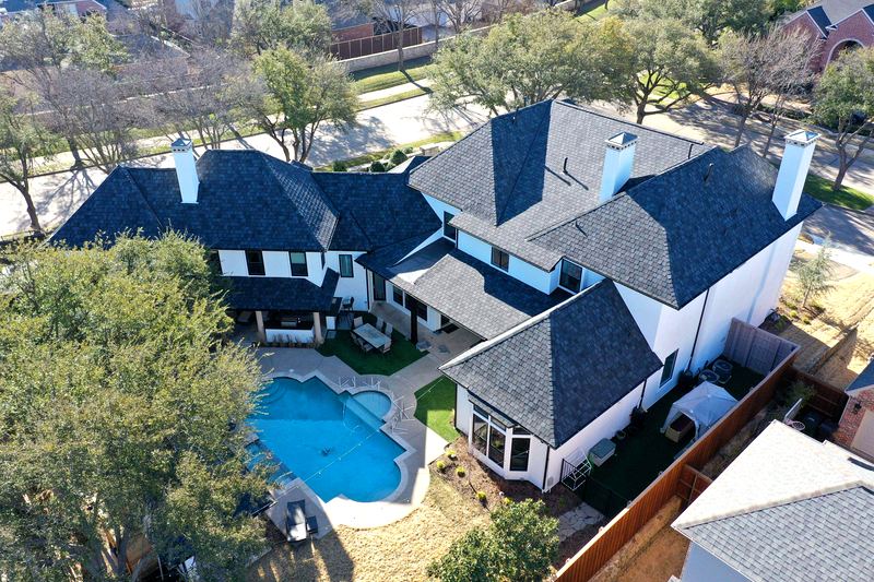 Newly replaced asphalt shingle roof on a Garland, TX home by Benchmark Roofing