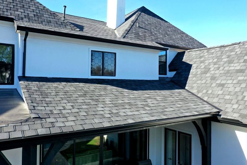 Insurance-claim roof replacement after storm damage by Benchmark Roofing